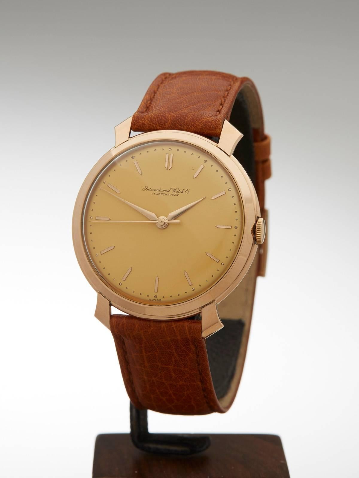 
Ref: COM606
Conditions: 9 - Excellent Condition
Age:	1960
Case Diameter: 37 mm
Case Size: 36.8mm
Box And Papers: Period IWC box
Movement: Mechanical Wind
Case: 18k Rose Gold
Dial: Gold
Bracelet: IWC strap
Strap Length: Adjustable up to 20cm
Strap