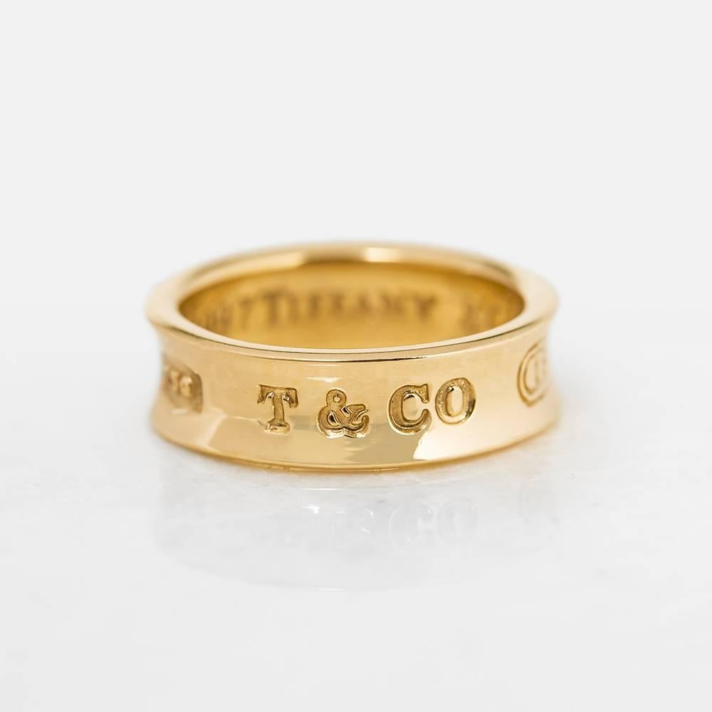 Ref:	COM1151
Age: 1997
Size: M 1/2, Band Width - 5mm
Box & Papers: Xupes Presentation Box
Material: 18k Yellow Gold, total weight - 7.65 grams
Condition: 9 - Excellent condition

This Ring by Tiffany & Co. is from their 1837 collection and features