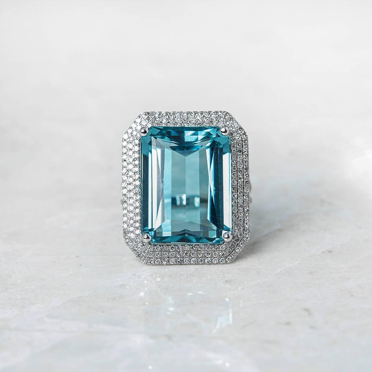 Ref:	COM458
Size:	 M.5
Box & Papers: Xupes Presentation Box
Material: 14k White Gold, total weight - 9.17 grams
Gemset: Set with 1 emerald Cut Aquamarine of 24.00ct with 3 rows of round brilliant cut Diamonds of 1.00ct total
Condition: 9 -