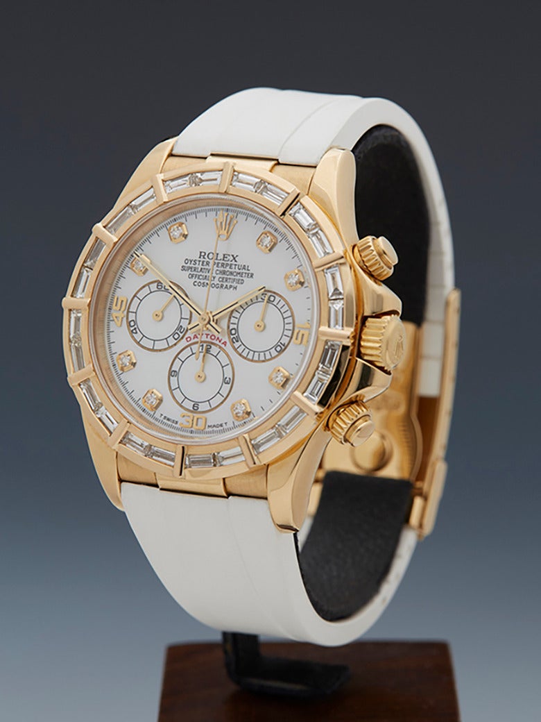 Specifications

Movement: Automatic
Case: 18k Yellow Gold with Custom Baguette Diamond Bezel
Case Diameter: 40mm
Dial: White Mother of Pearl with Diamond Markers
Bracelet: White Rubber
Strap Length: Adjustable up to 20cm
Strap Width: 	At