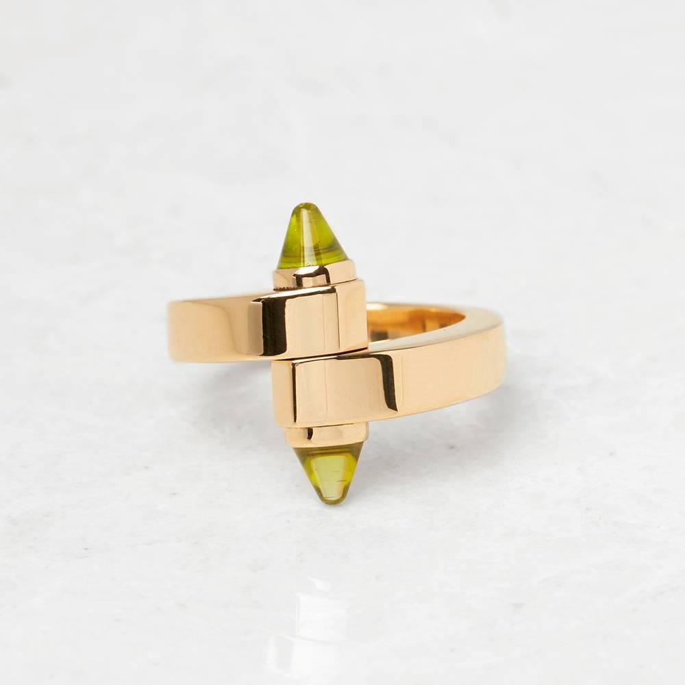 Ref:	COM1276
Serial Number: CN7***
Age:	 2000's
Size:	 K.5, Band Width - 3.5mm
Box & Papers: Cartier Pouch
Material: 18k Yellow Gold, total weight - 15.99 grams
Gemset: Set with 2 Peridots
Condition: 8 - Good condition

This Ring by Cartier is from