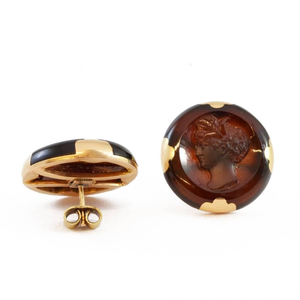 A pair of carved carnelian cameo earrings with gold inlay. English circa 1860