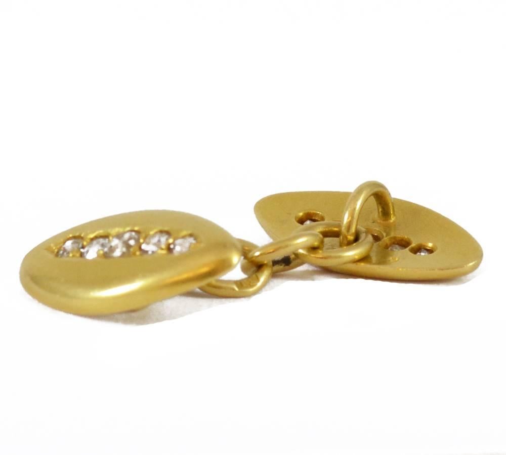 A pair of Victorian lozenge shaped cufflinks with a line of five graduated old cut diamonds down the centre of each one. 18ct yellow gold. English circa 1880.
