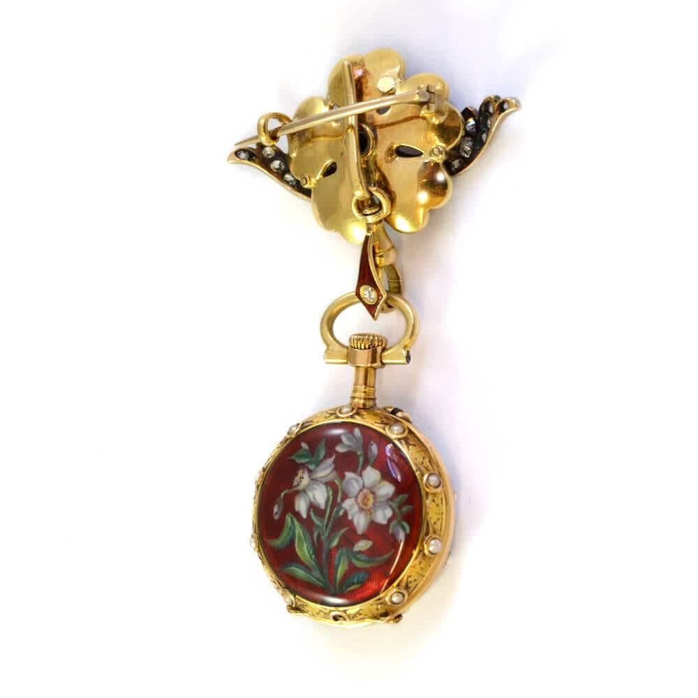 A diamond set fob watch decorated in enamel with daffodils on a dark red ground. 18ct yellow gold and silver. English circa 1880. Movement by Le Coultre.