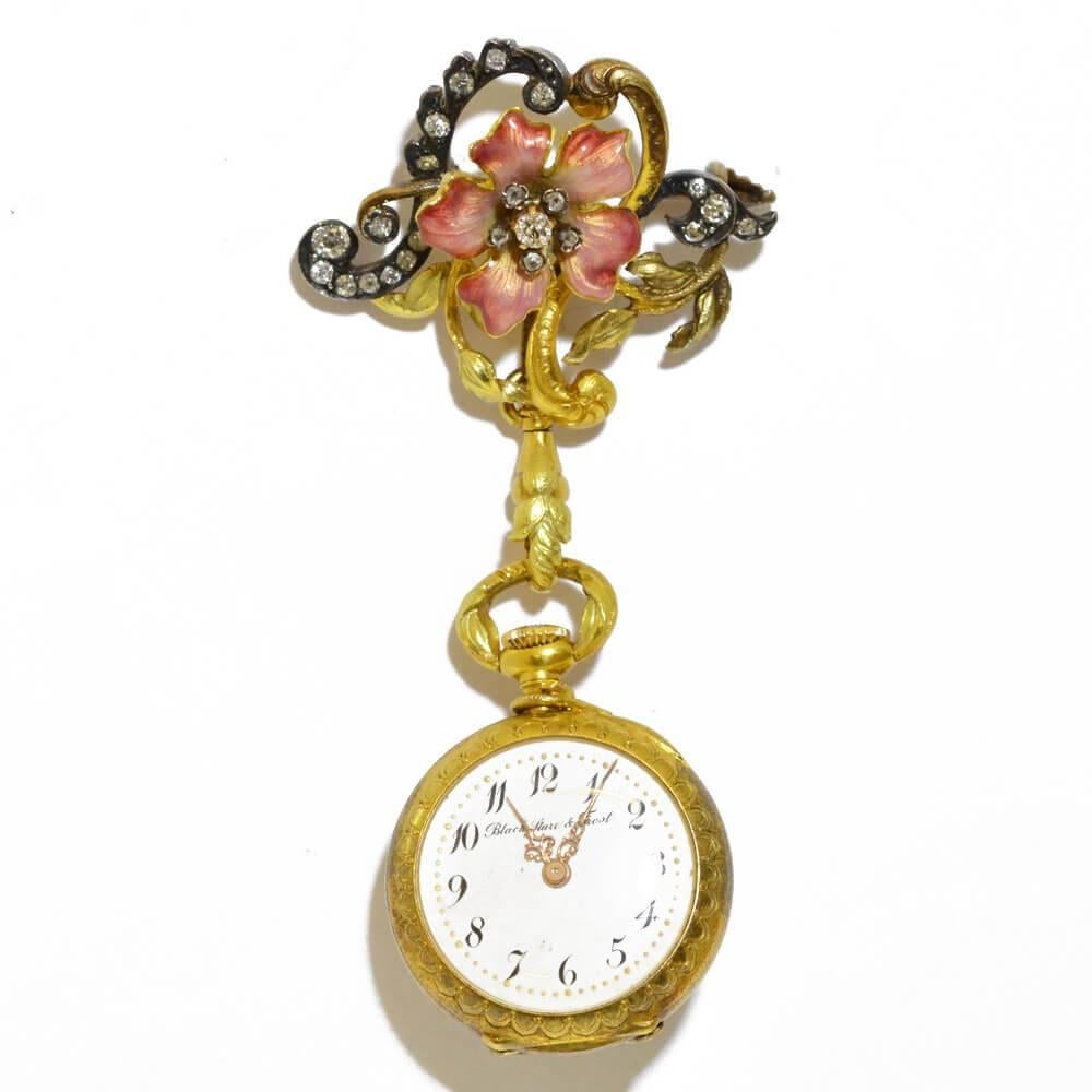 An Art Nouveau pendant watch by Black, Starr & Frost, depicting an enamel and diamond set pink wild rose. Mounted in silver and yellow gold. American, circa 1900.