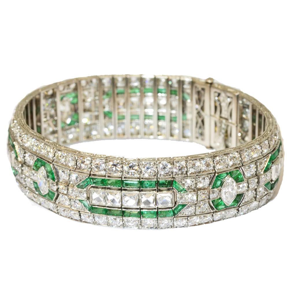 An Art Deco emerald and diamond set bracelet. The central row on the bracelet is alternately set with a row of five French cuts and a marquise diamond, all within individual frames of rectangular cut emeralds. Mounted in platinum. By Oscar Heyman &