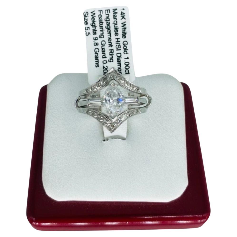 Vintage 1.00 Carat Center Marquise Diamond Ring W/Guard Platinum 14k White Gold. The center diamond is a Marquise cut and is H/SI and is the ring is made of platinum 900. The guard ring features surrounding diamonds that equal a total of 0.20