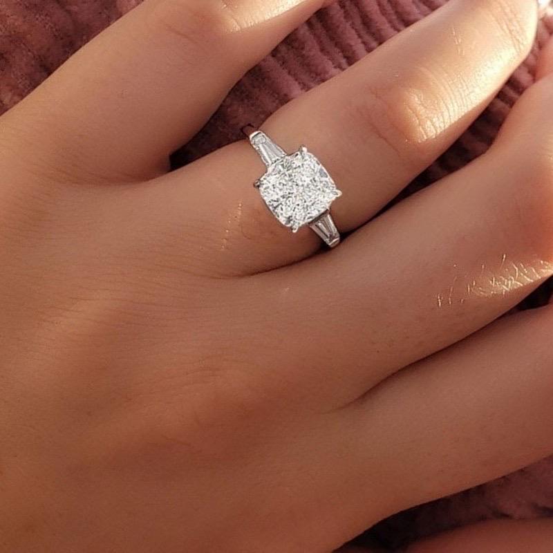 This beautiful Cushion Cut Diamond Engagement Ring features a stunning 3 carat Solitaire with perfectly matched tapered baguettes flanking the 2 sides of the ring to deliver timeless class and elegance. 

Center Diamond Shape: Cushion 
Center