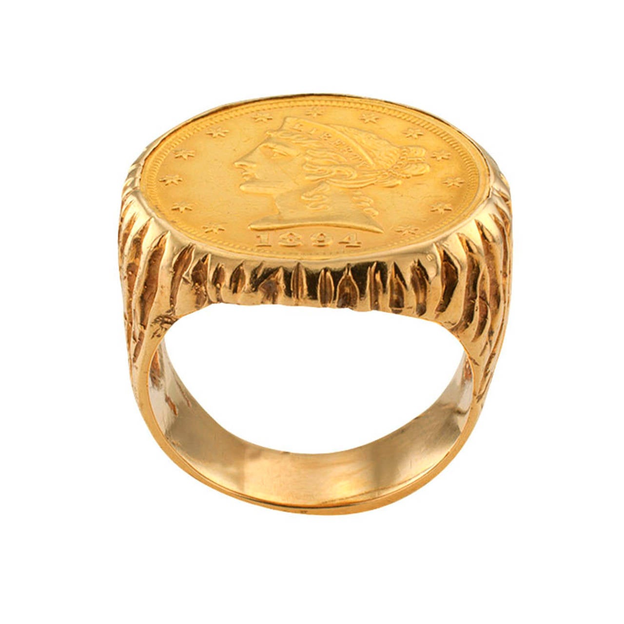 1894 US $5.00 Liberty Gold Coin Ring, Circa 1970

Featuring a US $5.00 Liberty gold coin dated 1894, bezel-set on a bold and handsome 14 karat gold mount decorated with deeply engraved organic motifs, ring size 10 plus, approximately 1