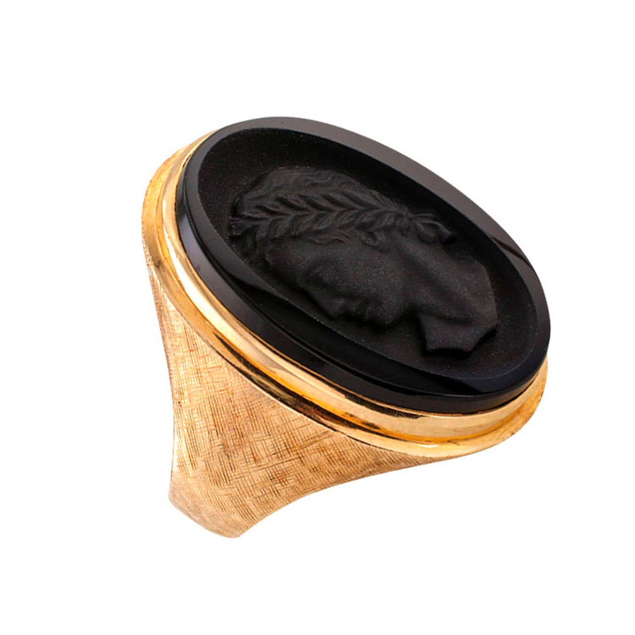 Carved Cameo Black Onyx Ring

Circa 1960.  Bold in scale with handsome lines and rich Florentine details, centering upon an oval black onyx cameo carving depicting a classical head profile, mounted in 14 karat yellow gold, ring size approximately