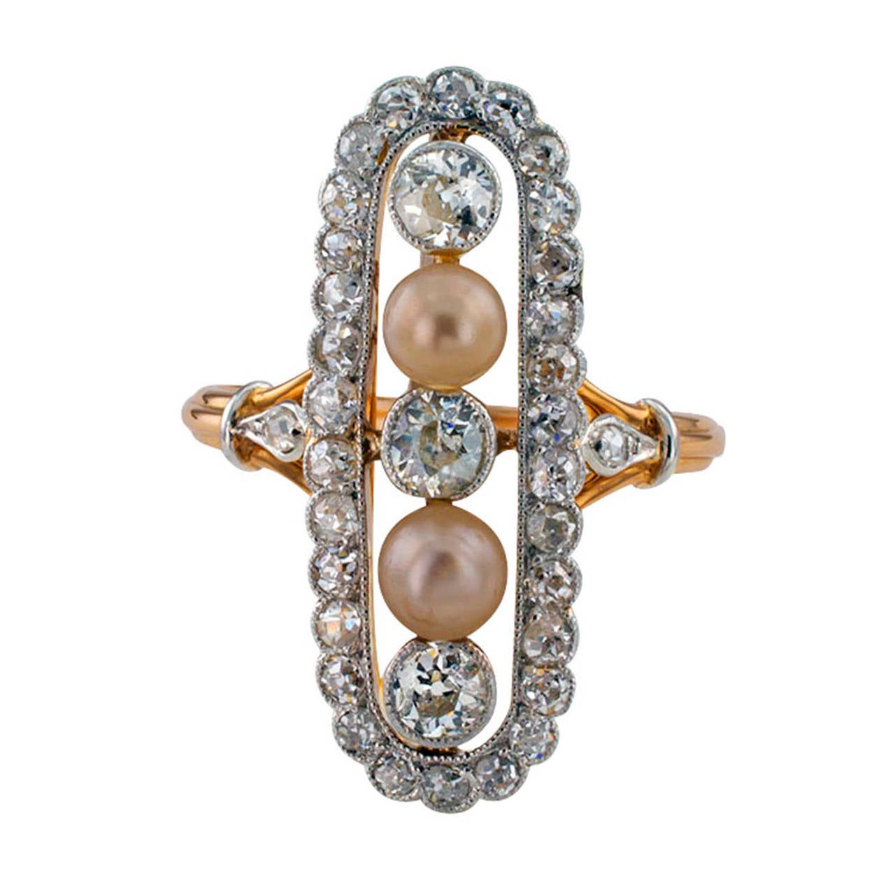 Unique ring, circa 1910. The design features an open oblong-shaped motif set with three old European-cut diamonds and a pair of pearls measuring approximately 4 mm, within a conforming border of rose-cut diamonds, the thirty-five diamonds totaling