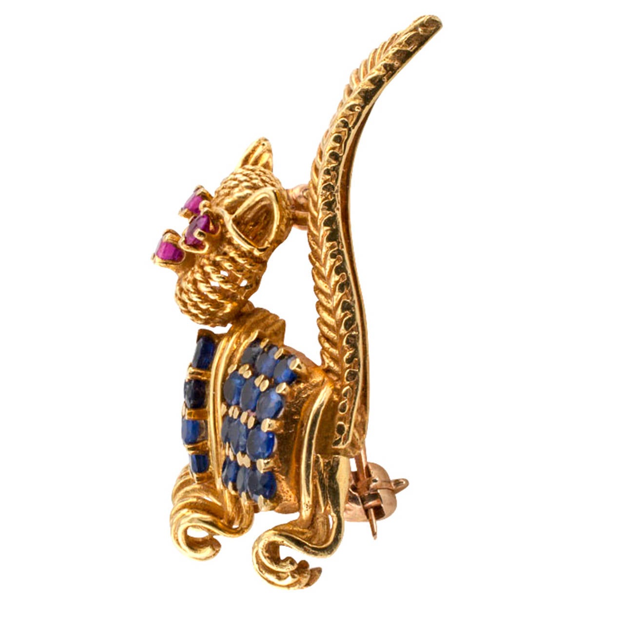 Tiffany & Co. Whimsical Ruby and Sapphire Cat Brooch

This adorable Tiffany Cat Brooch is quite whimsical.  Circa 1960's, the open work design features ruby eyes and nose and the body is accented with sapphires.  Mounted in 18 karat yellow gold,