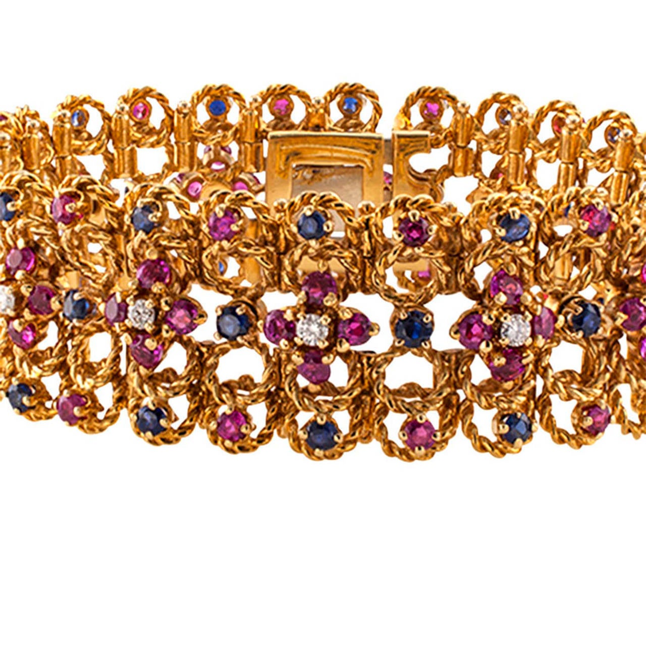 Wide Ruby Diamond and Sapphire Bracelet

This 18 karat gold bracelet,  with open work design resembles a shimmering ribbon composed by tiny rings of corded gold set throughout with diamonds weighing approximately 0.75 carat, approximately VS