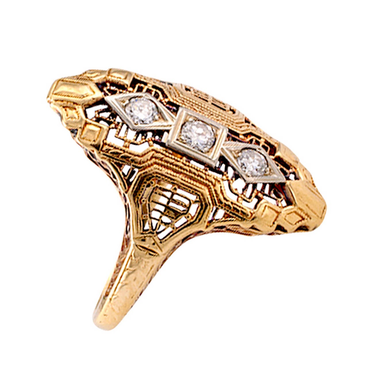 There is not a lot of authentic Art Deco jewelry in yellow gold. Circa 1930, this enticing dinner ring design is low profile and decorated with a lot of filigree, set with three circular-cut diamonds totaling approximately 0.25 carat, 14 karat gold,
