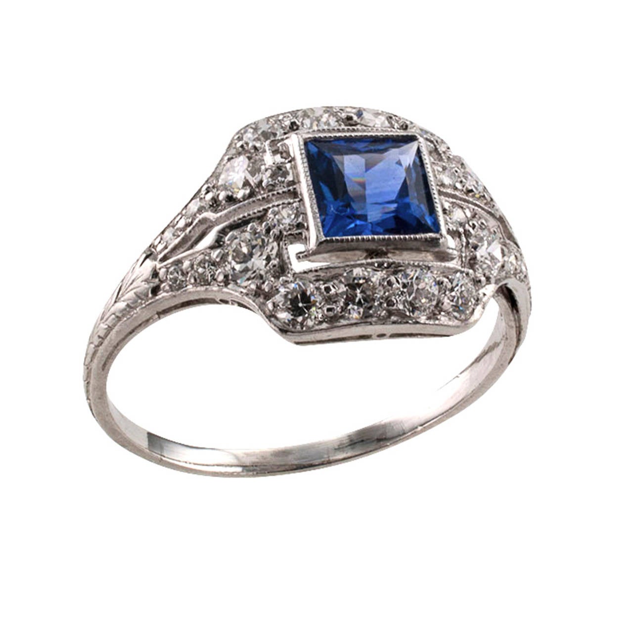 Sapphire and Diamond Art Deco Ring

 This authentic Art Deco jewel, circa 1925, features a square-cut blue sapphire weighing approximately 0.75 carat, bezel-set on a sparkling, slightly domed platinum mount set throughout with smaller round