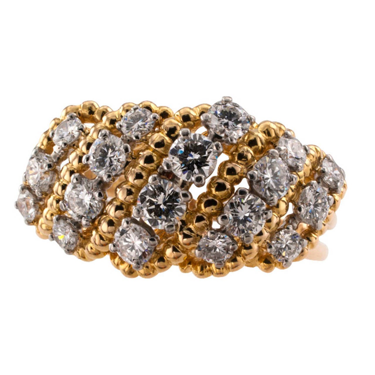 Oscar Heyman Diamond Ring

Slightly domed, this open work ring sparkles with 18, top grade, round brilliant-cut diamonds divided into five graduating platinum courses set across the ring between scrolling beaded gold motifs allowing plenty of
