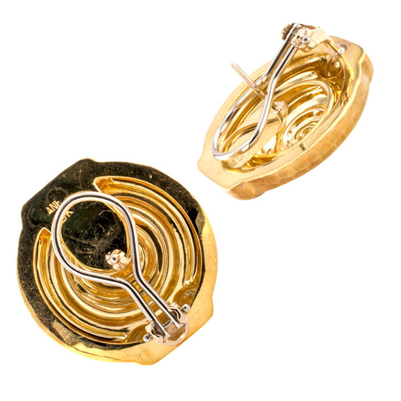 Hammered Gold Earrings

Circa 1980, Greek inspired, these earrings have a classic design with a twist, the perfect  go-to every day pair of gold earrings.  A spiraling motif with scrolled terminals serves as ground for a hammered texture on matte