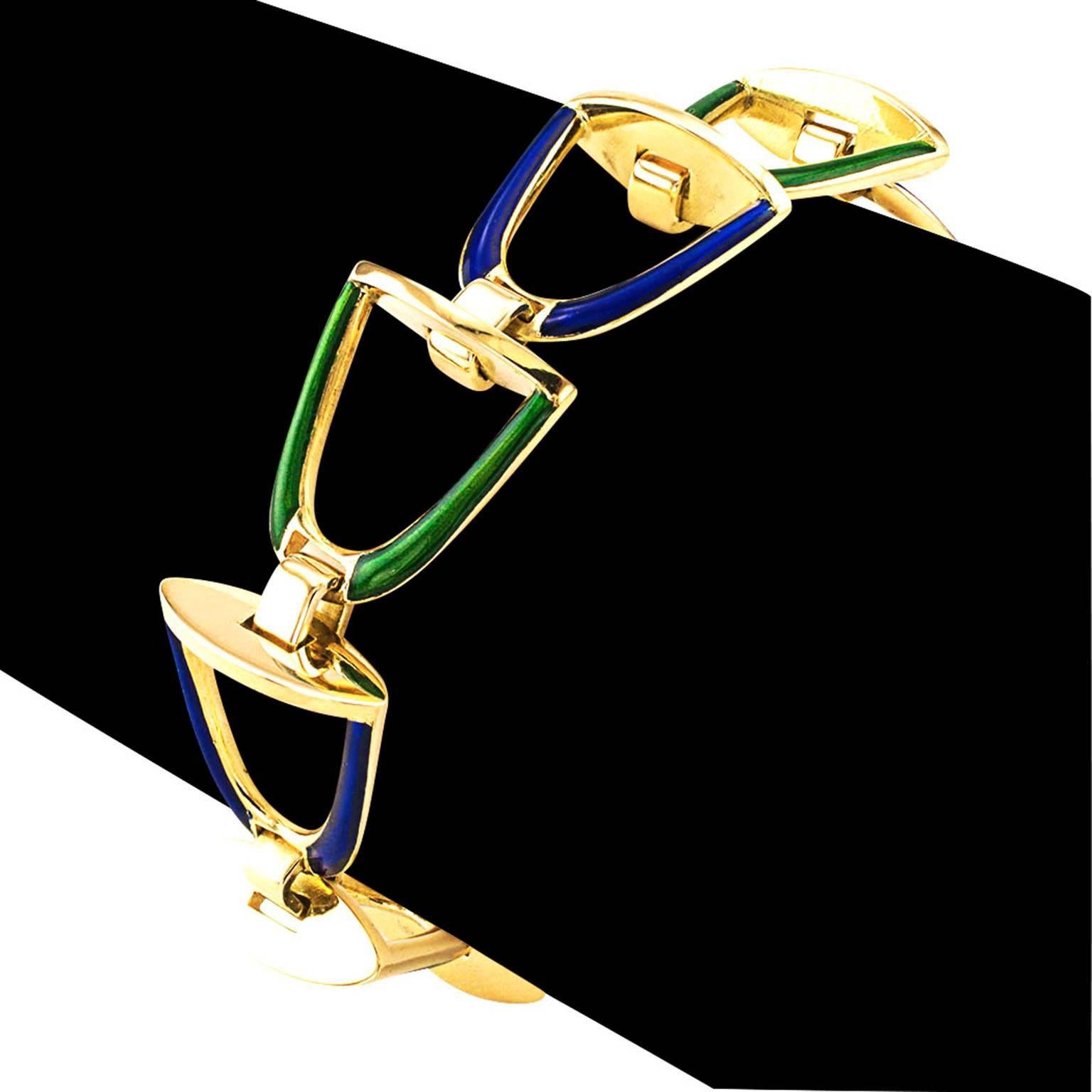 Equestrian Blue and Green Enamel Stirrup Bracelet

Equestrian done differently, simple in design, with a color palate that is attractive, neutral to other colors and irresistible to the eye.  A series of linked stirrups decorated with alternating
