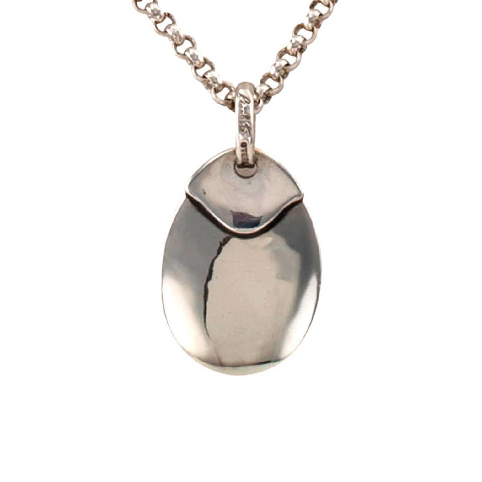 Rigoberto Sterling Silver Dog Tag Pendant

Suitable for engraving with geometric accents, the pendant 1 1/2" long and 7/8" wide, suspended from a sterling silver 4 mm 19" long rolo chain.  Signed Rigoberto, made in the USA, crafted