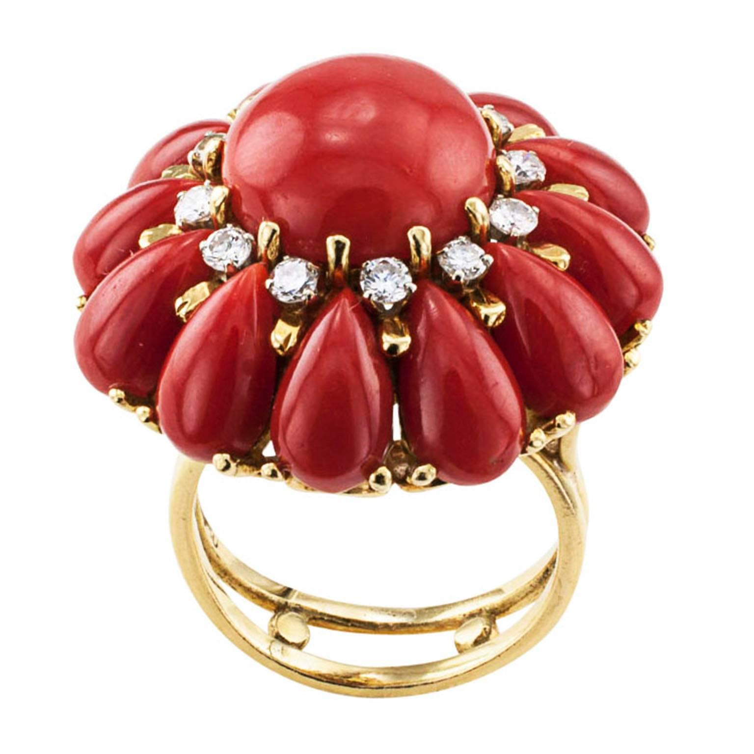 Red Coral and Diamond Round Cocktail Ring Circa 1970

A beautiful and most exotic flower for your hand, madam.  What could be better?  The alluring mystique of red coral and a circle of twelve diamonds (One for each month of the year!)to assert