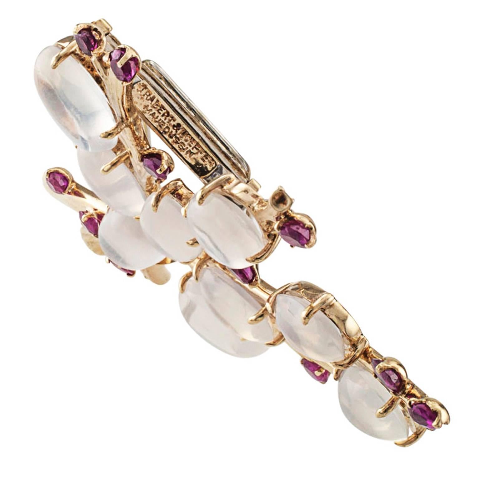 Trabert and Hoeffer Mauboussin Retro Brooch

   A romantic retro composition suggesting pussy willow branches realized via a clever arrangement of moonstones and rubies in 14 karat yellow gold, all gathered with a diamond ribbon.  From the