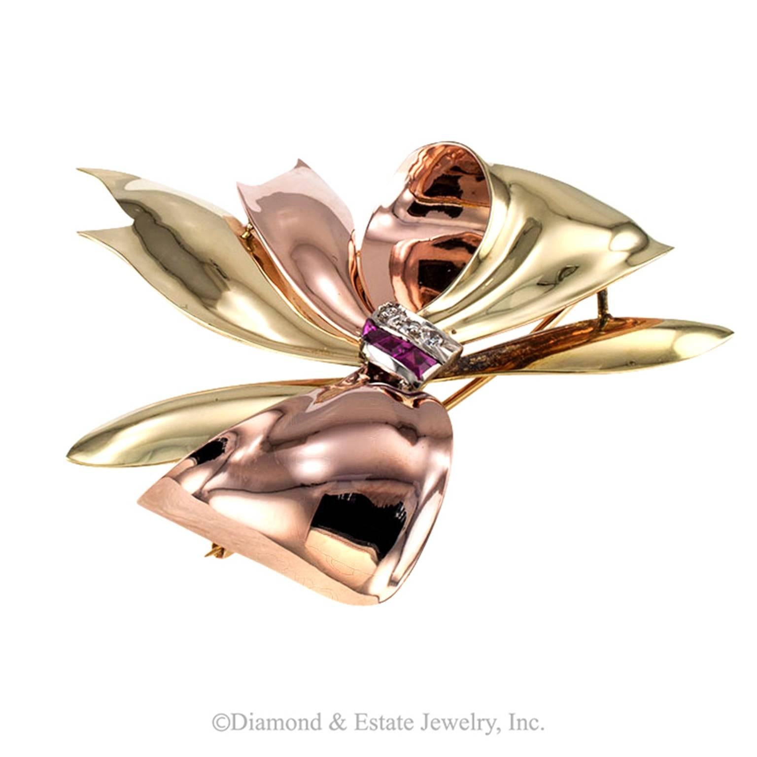Tiffany and Company Estate Ruby and Diamond Retro Bow Brooch

Handcrafted in three very distinctive shades of 14 karat gold accented with calibrated rubies and four diamonds totaling approximately 0.12 carat.  The use of various colored metals is