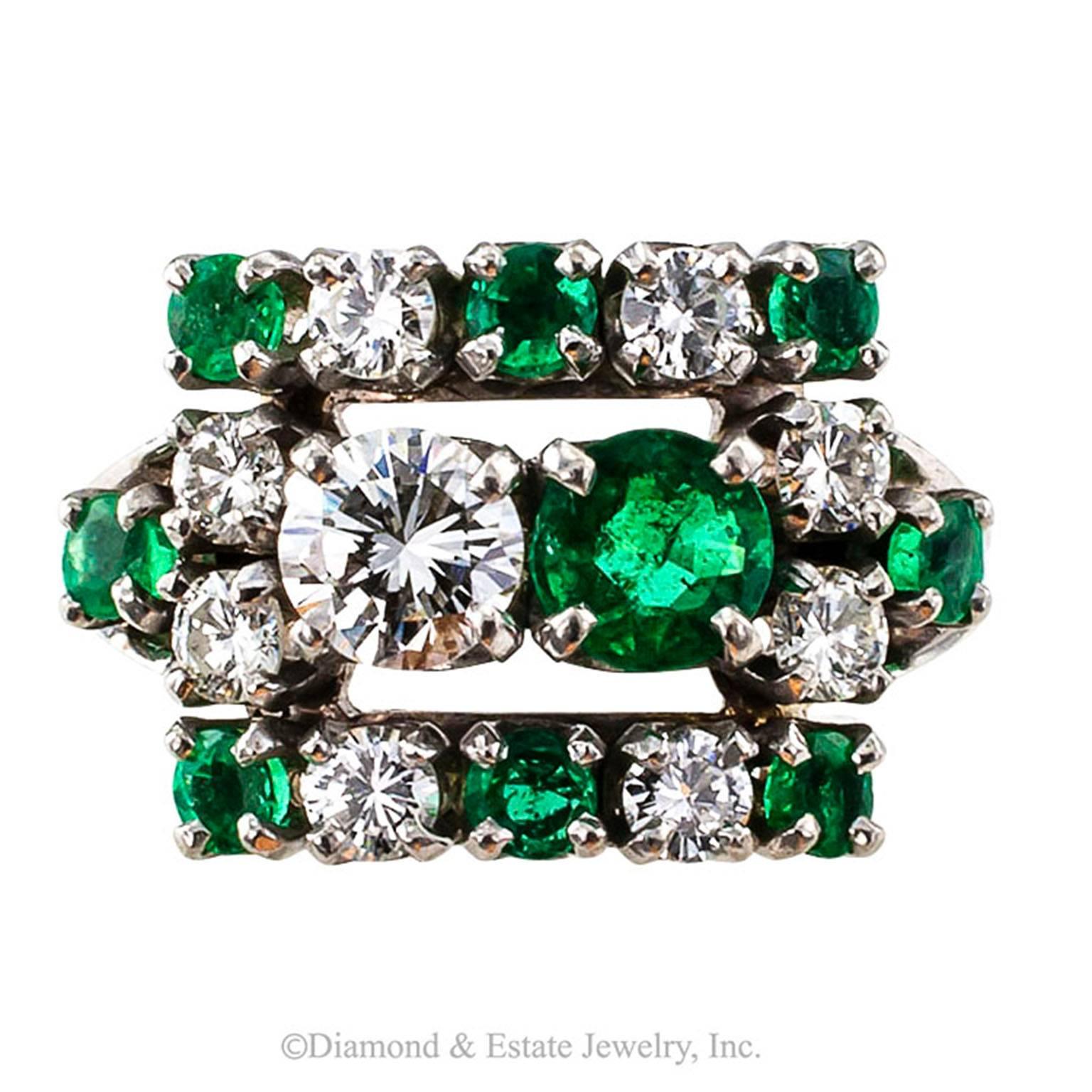 Mid Century Emerald and Diamond Ring

Emeralds and diamonds make such a dynamic combination.  Elizabeth Taylor sure loved it.  She even named a perfume after it.  This ring is a charmer and at first glance the eyes are tricked into believing that