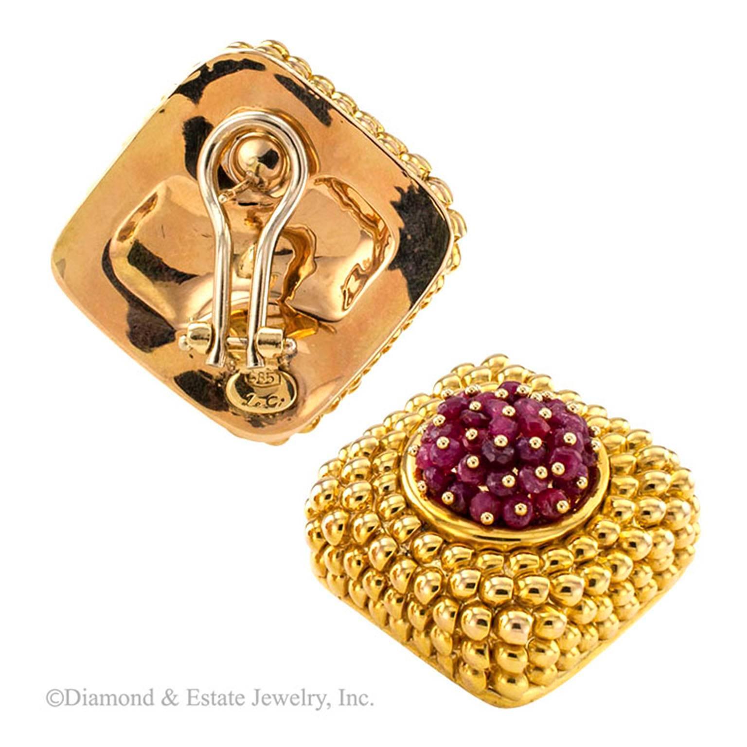 Ruby and Yellow Gold Estate Earrings

Candy like in appearance, these earrings are a radically different way to wear ruby and gold together.  Those yummy looking centers are filled with randomly arranged, faceted ruby beads. Each is held in place