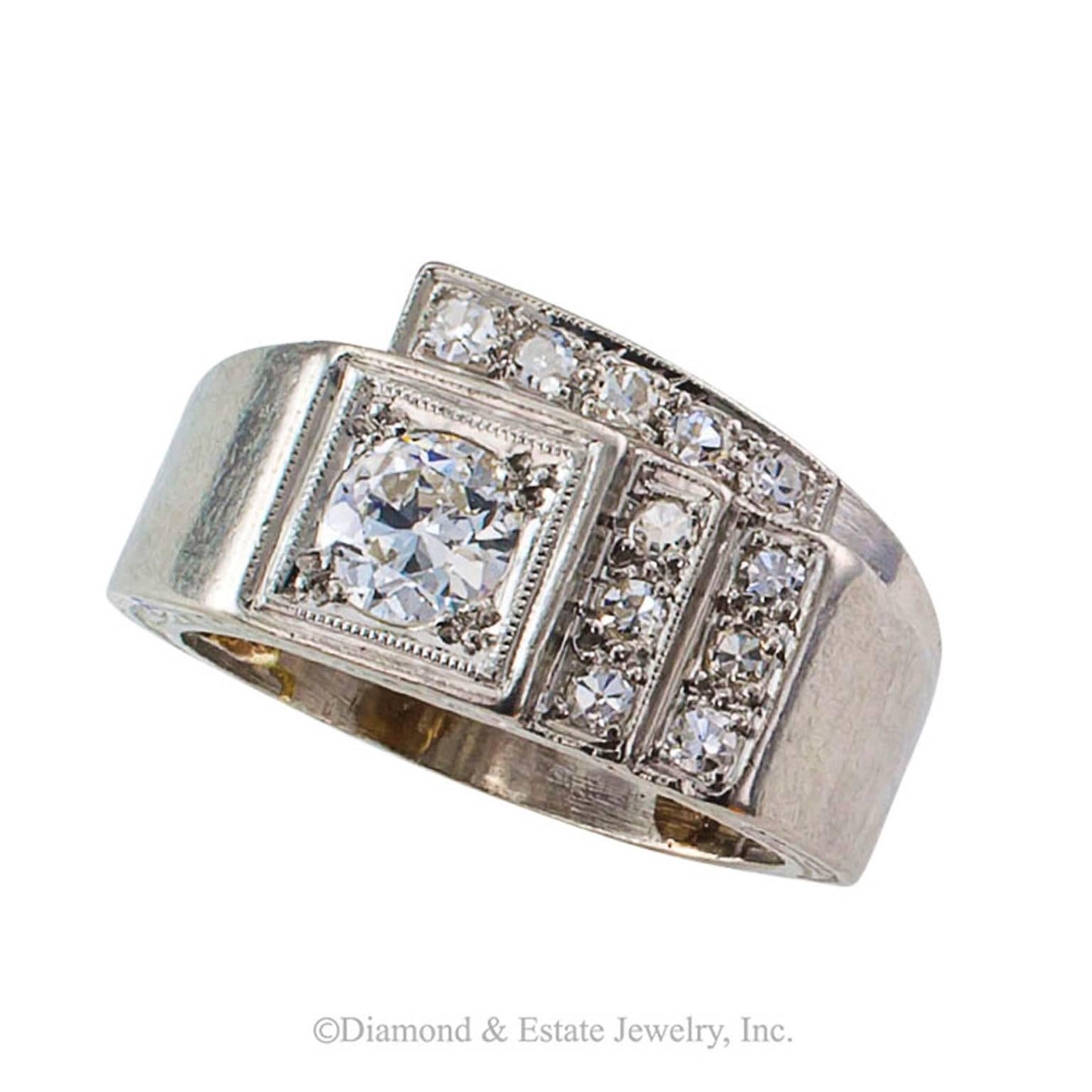 1930s Art Deco Diamond Platinum Geometric Ring

Art Deco to the max... handmade in platinum, the exquisite geometry stepped and set with eleven smaller diamonds totaling approximately 0.17 carat, playing off center to a larger old European-cut
