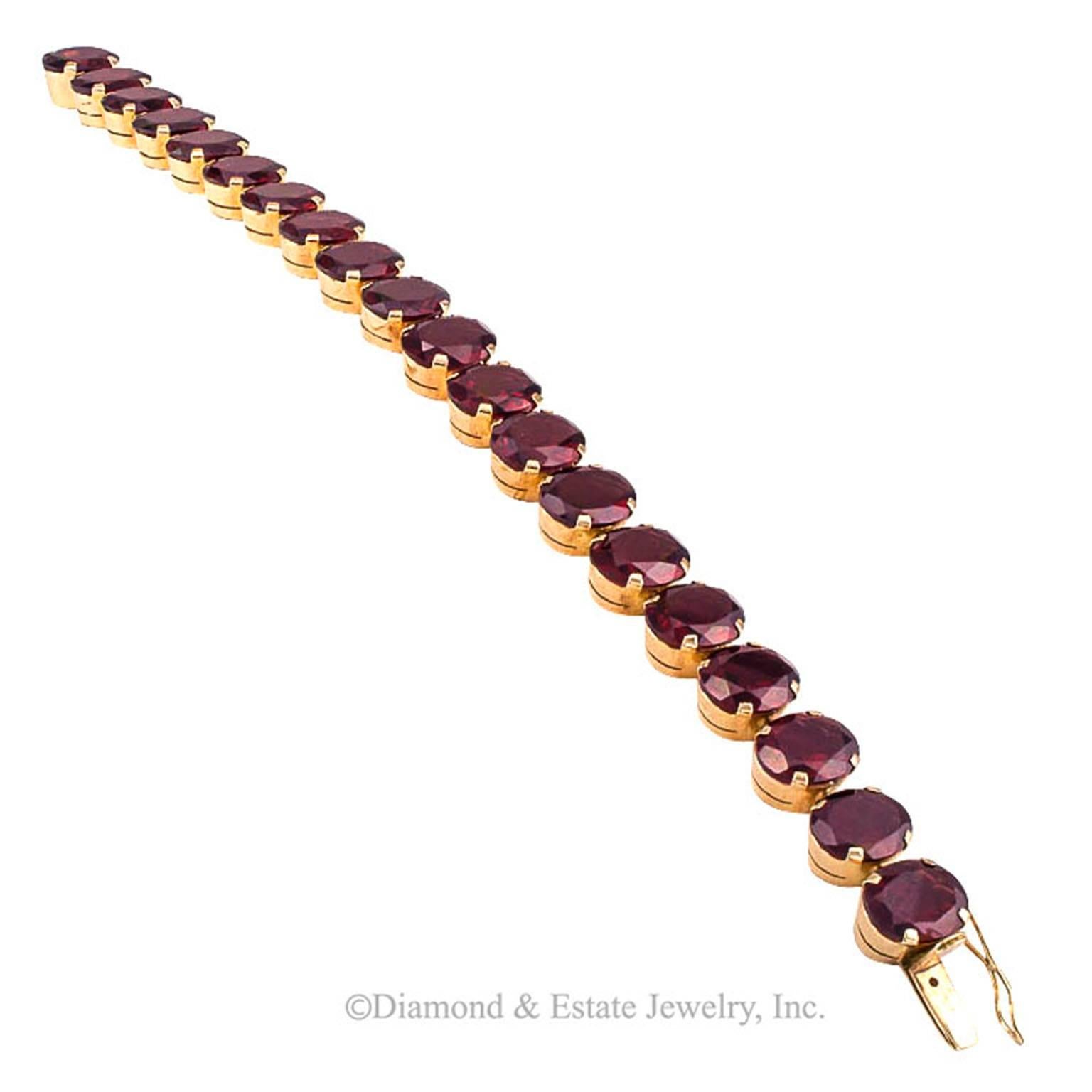 1940's Retro Garnet Line Bracelet

No ordinary garnet line bracelet.  Twenty good-size faceted oval garnets radiating with deep burgundy wine color... the way old garnets used to look... seventy-five carats approximately  total weight.  Mounted in