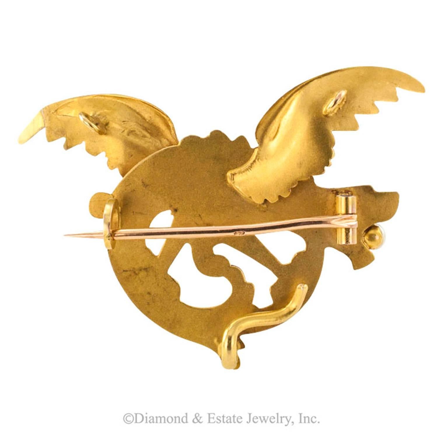French Antique 18-Karat Gold Dragon Brooch

18-karat gold Art Nouveau dragon brooch with ruby eye and pearl-gripping tongue, French hallmarks, very pristine.  The back side fitted with a hook and a pair of loops on the wings to facilitate