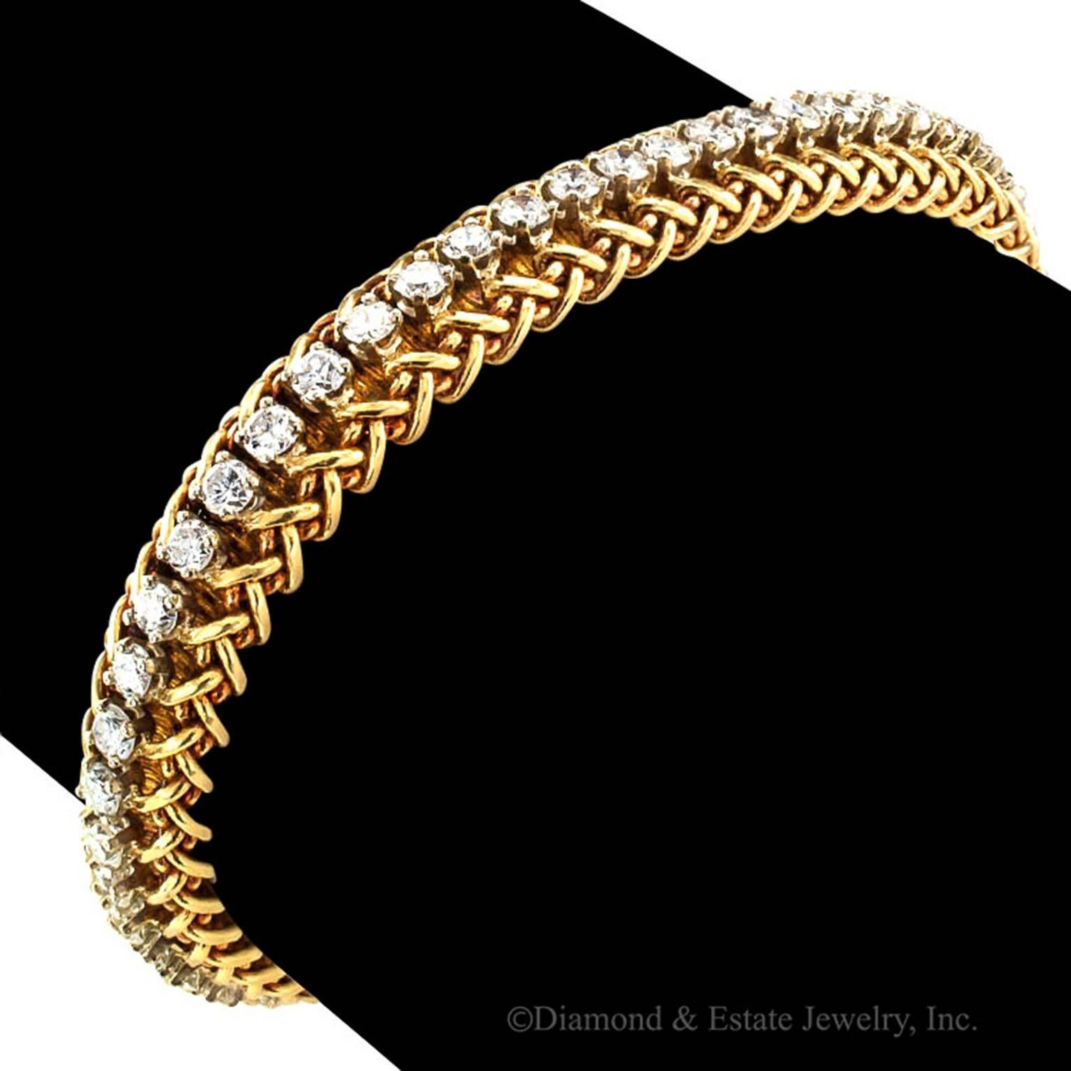 1970's Estate Gold and Diamond Line Bracelet

The delicate and feminine lines belie its beauty and strength.  How wonderful is that?  A sturdy bracelet comprising a flexible woven gold strap centering a course of fifty-six round brilliant'cut