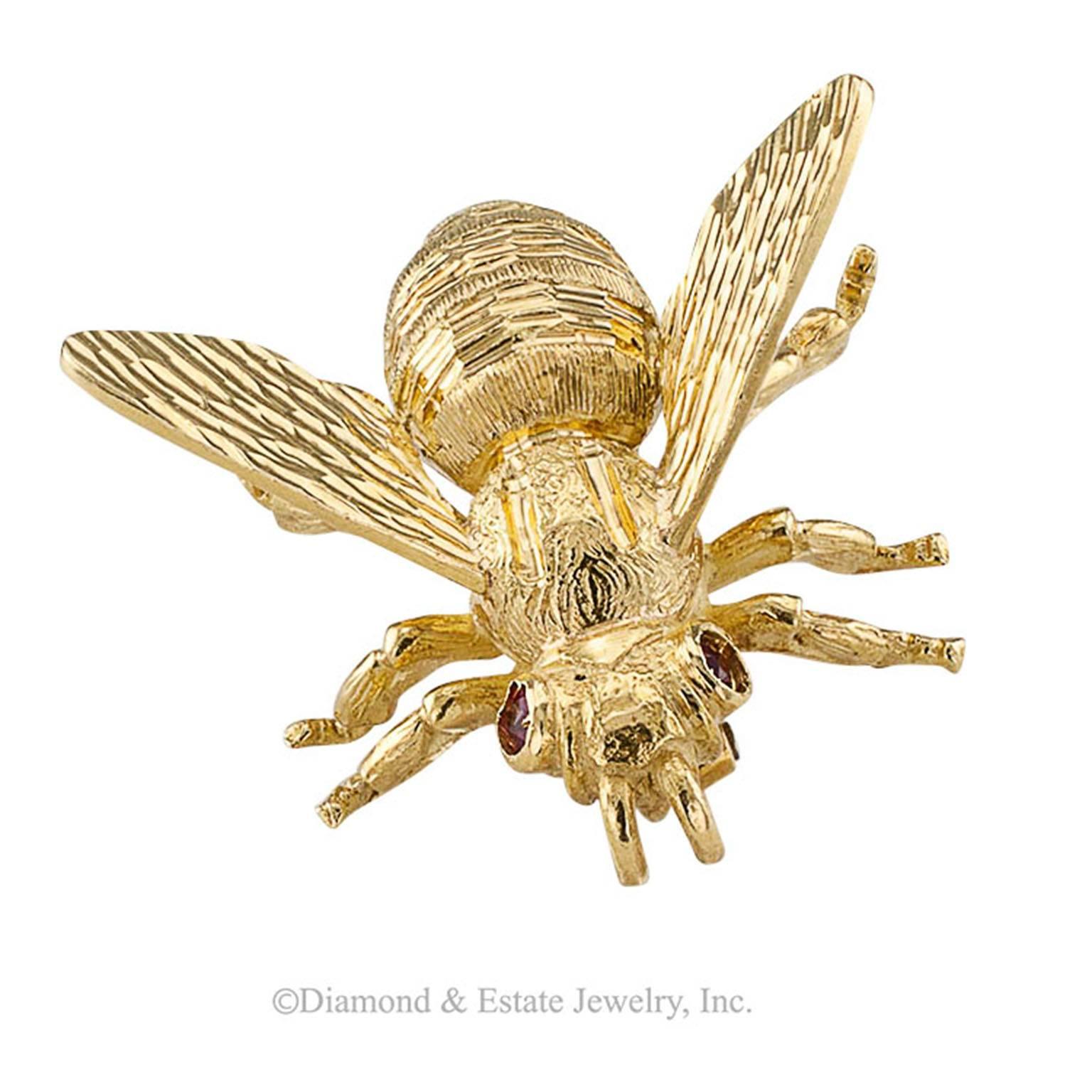 1970s 18-Karat Gold and Ruby Bee Brooch

Italian, 18-karat yellow gold bee pin with ruby eyes, circa 1970.  Buzzing right along with the very best of them, not shy about the exquisite hand engraved details on its body and wings, this little bee is