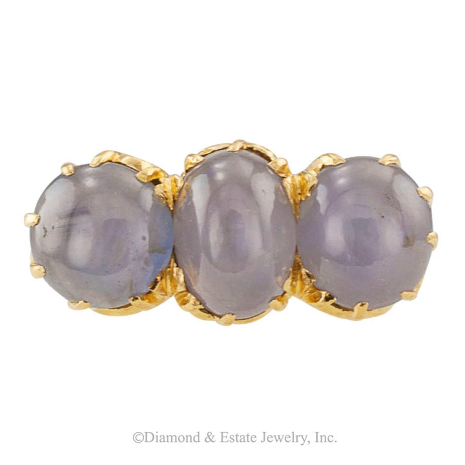 Arts and Crafts Star Sapphire Three-Stone Ring

Arts and Crafts three stone ring featuring a trio of star sapphires totaling approximately 11.50 carats, mounted in 18-karat yellow gold, circa 1900.  The sapphires display strong, well defined
