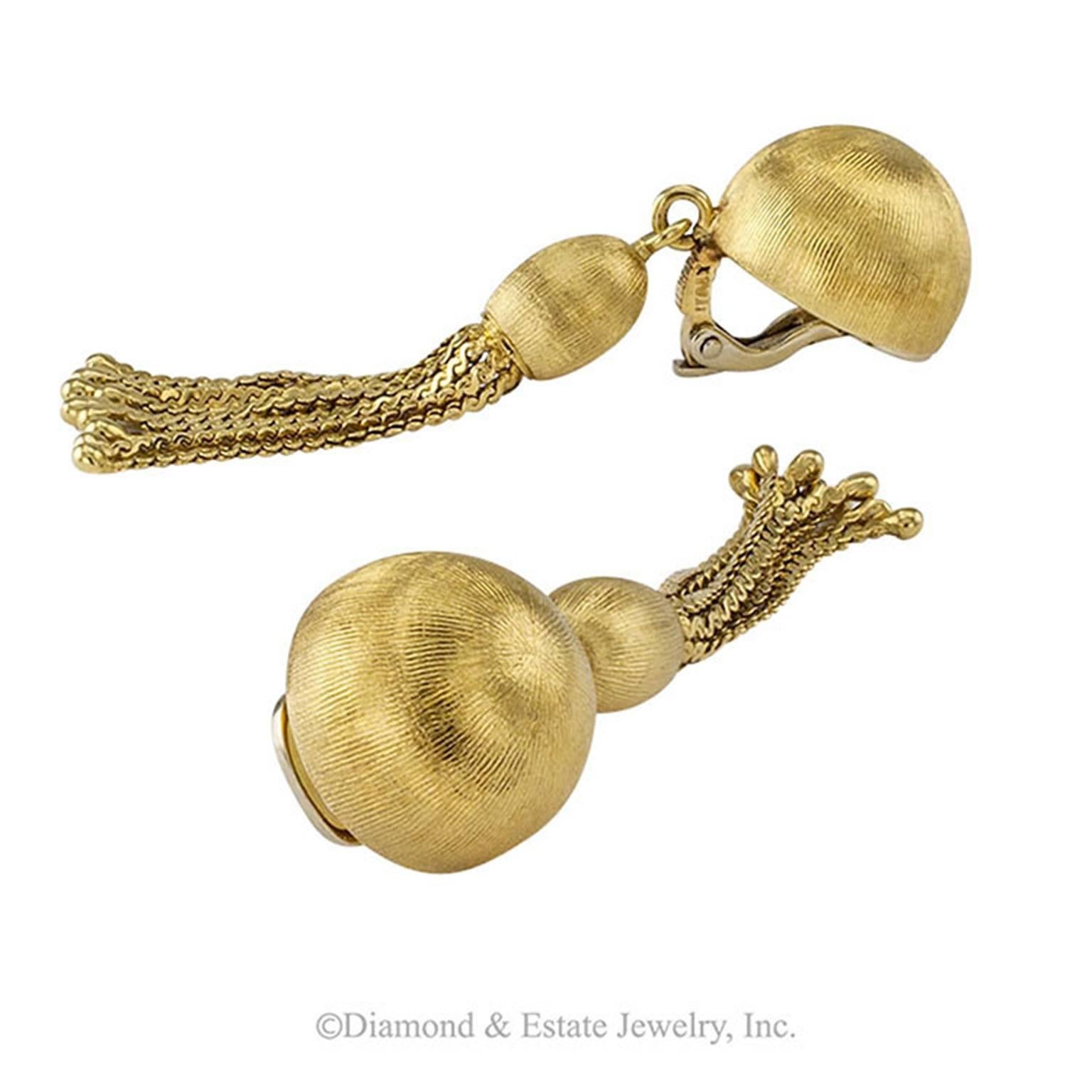 18-Karat Gold Swinging ball and Tassel Ear Clips

Swinging ball and tassel 18-karat yellow gold earrings circa 1960.  The classic gold dome earring design elevated to Dancing With The Stars status by virtue of the pendant ball and tassel