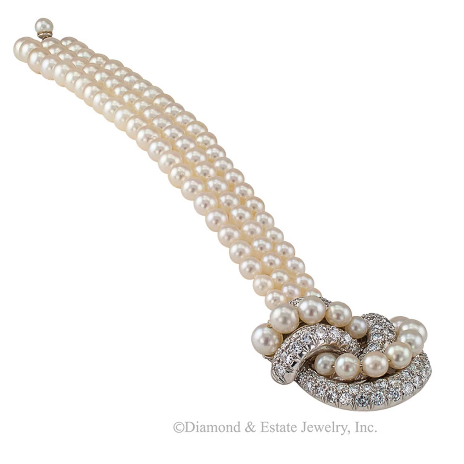 David Webb Pearl and Diamond Bracelet

David Webb triple strand cultured pearl and diamond clasp estate bracelet, circa 1950.  Comprising three stands of graduating cultured pearls, measuring from 4 - 7 mm, completed by diamond and cultured pearl