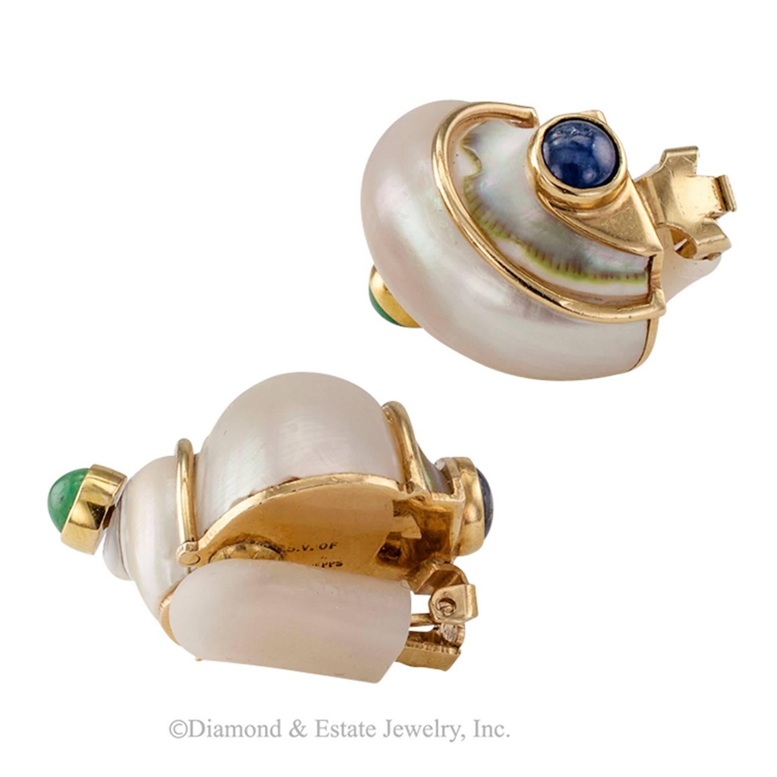 Seaman Schepps Natural Shell Emerald and Sapphire Earrings

Seaman Schepps classic shell ear clips featuring cabochon emerald tops and similarly cut sapphires on the bottoms, mounted in 14-karat gold, circa 1960. A basic must have