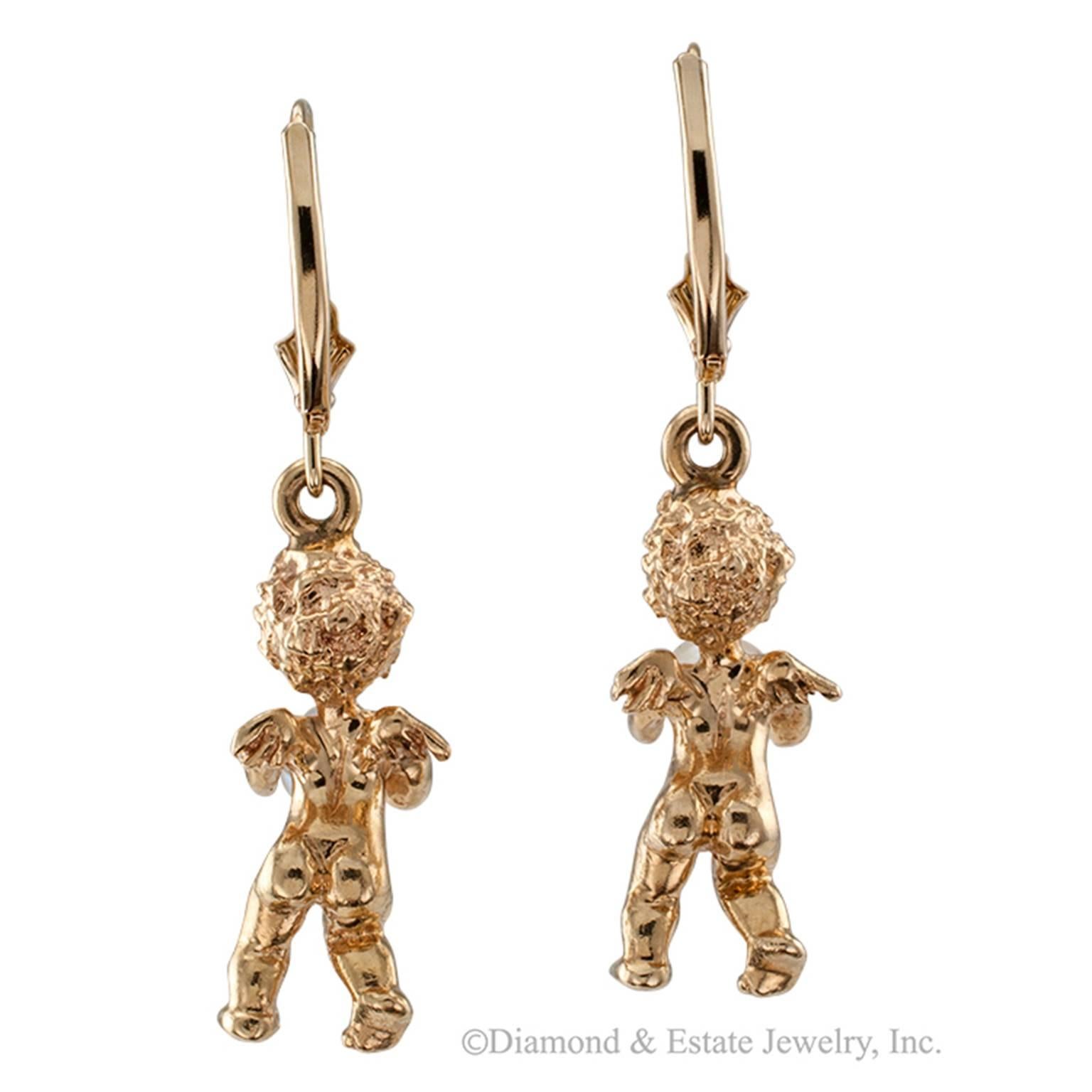 Attributed to Ruser Gold and Cultured Pearl Cherub Earrings

Cultured pearl sapphire and 14-karat gold cherub drop earrings circa 1950, attributed to Ruser.  These charming little angels give the impression of holding the whole world in the form