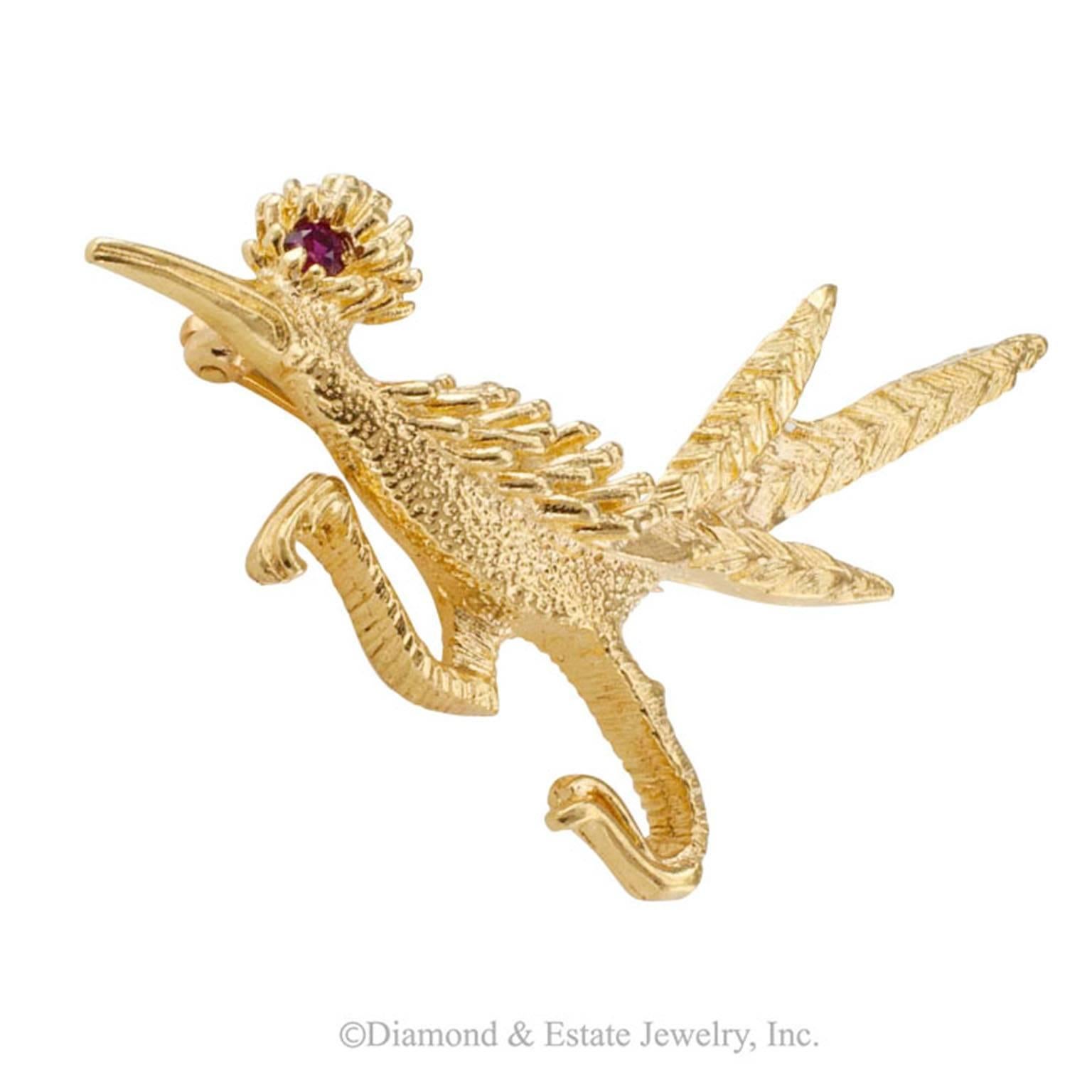 Road Runner 14-karat Gold and Ruby Brooch

1970s 14-karat yellow gold road runner brooch with ruby eye.  The whimsical design captures the agile spirit of the graceful road runner bird.  In real life, they are simply captivating... so expressive