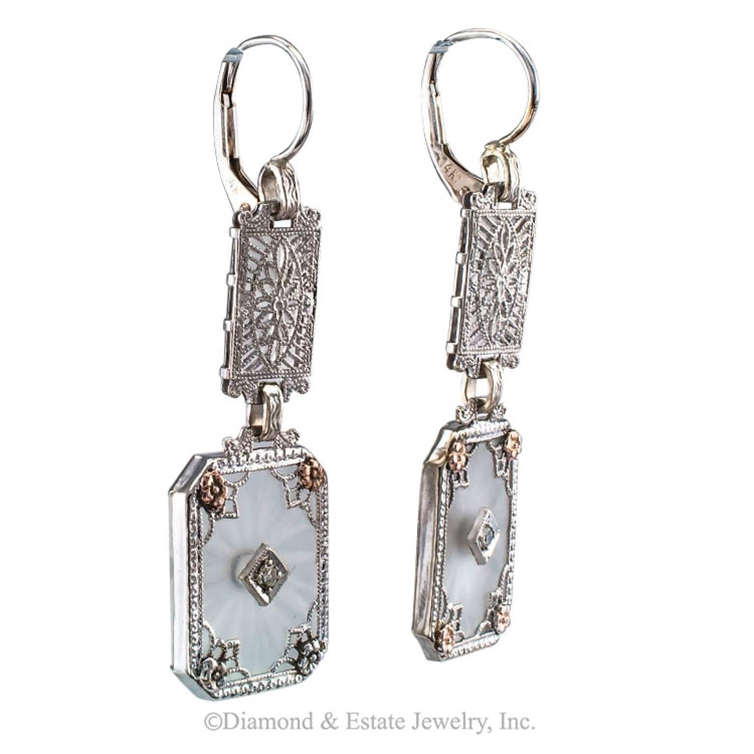 Art Deco Rock Crystal Diamond Gold Earrings

Art Deco rock crystal diamond gold filigree pendent earrings circa 1925.  The matching designs feature a pair of rock crystal plaques carved on the back and frosted on the front, each studded with a