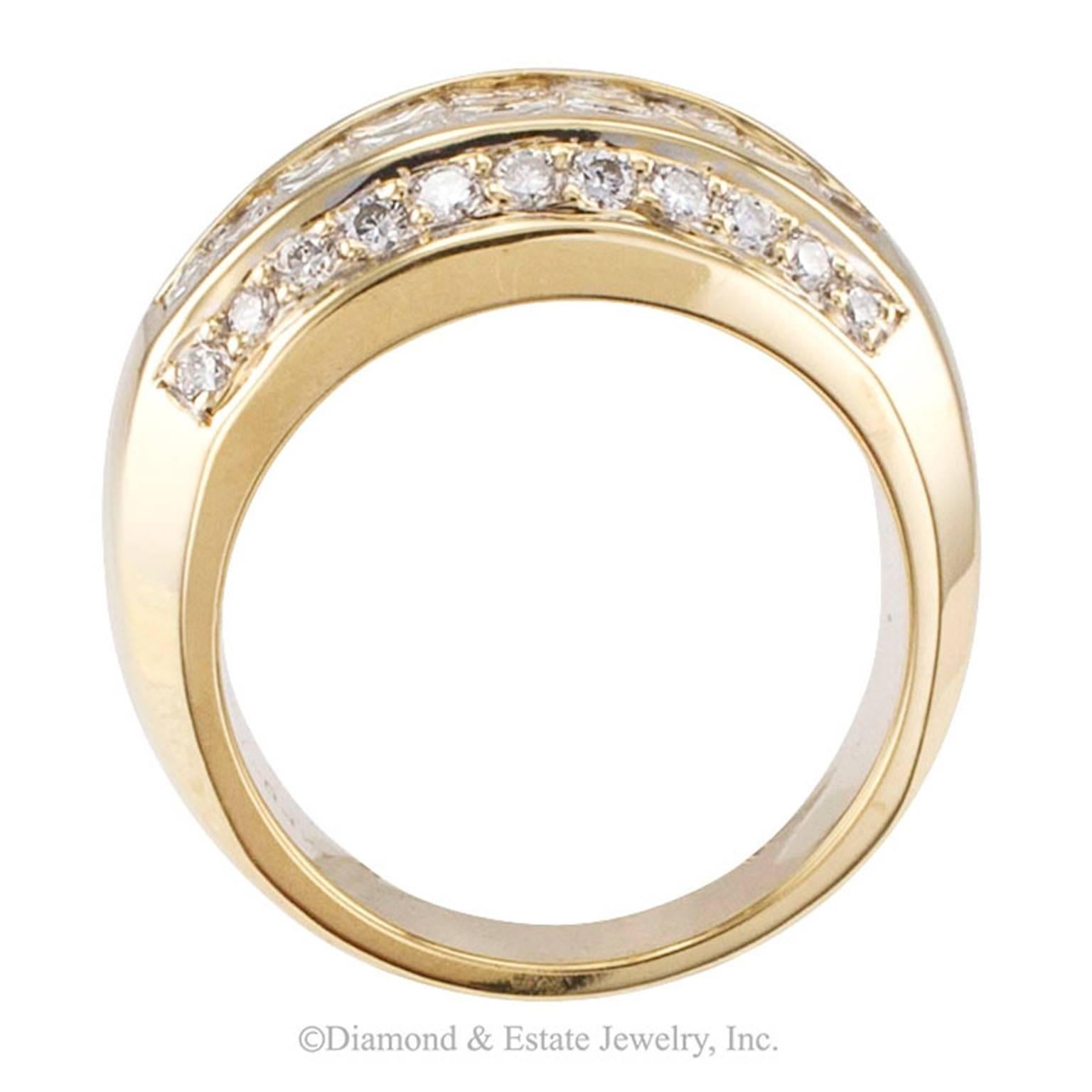 Wide Princess Cut Diamond Yellow Gold Band

Wide wedding band with invisibly-set princess cut diamonds mounted in 18-karat yellow gold, circa 1990.  The upper side of the design features three rows of invisibly set princess-cut diamonds, between
