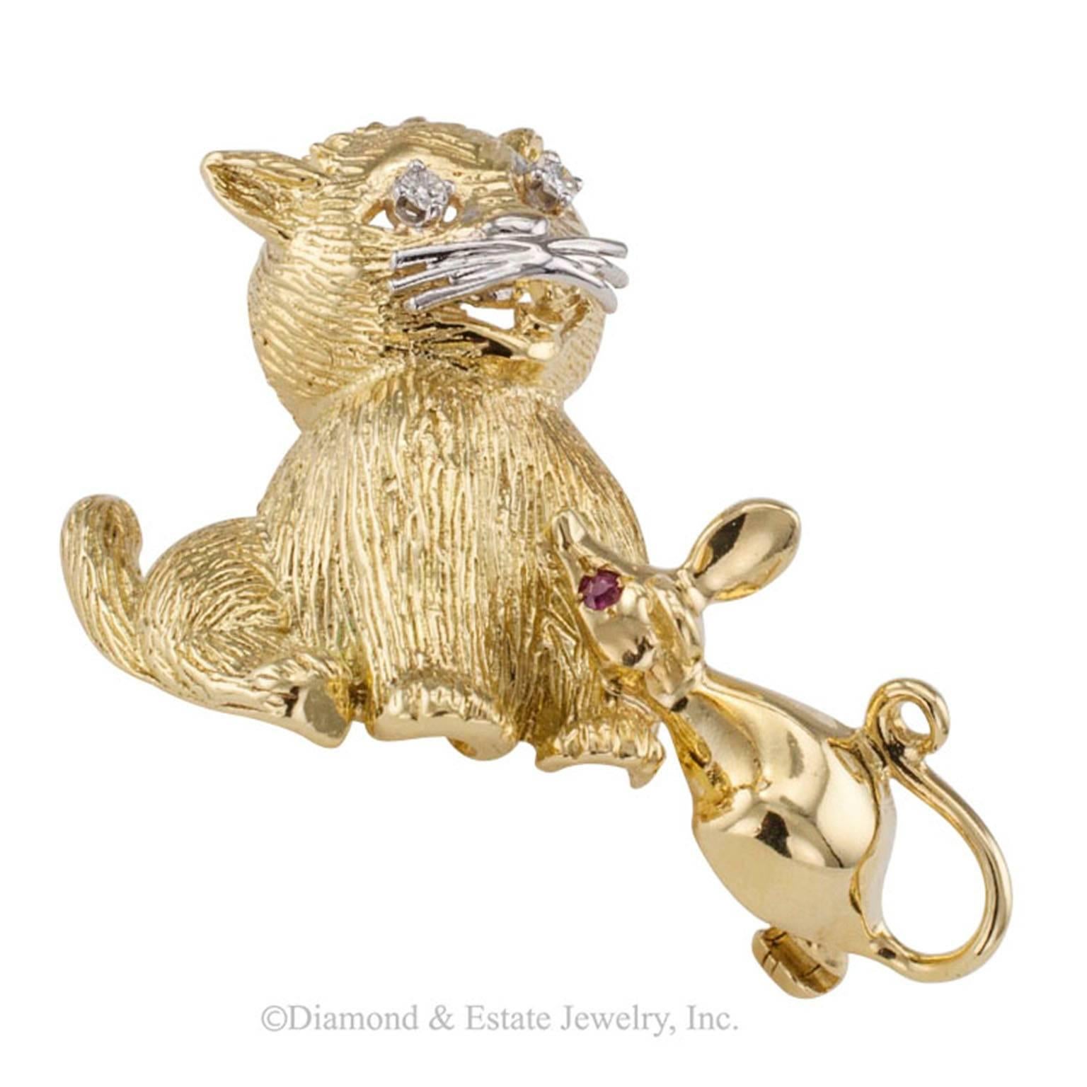 1960s Cat Mouse Ruby Diamond Gold Brooch

Cat and mouse gold brooch with diamonds and rubies circa 1960.  Seemingly a peaceful and harmonious tete a tete between cat and mouse... with stars in its eyes... the cat... looking quite smug... silently