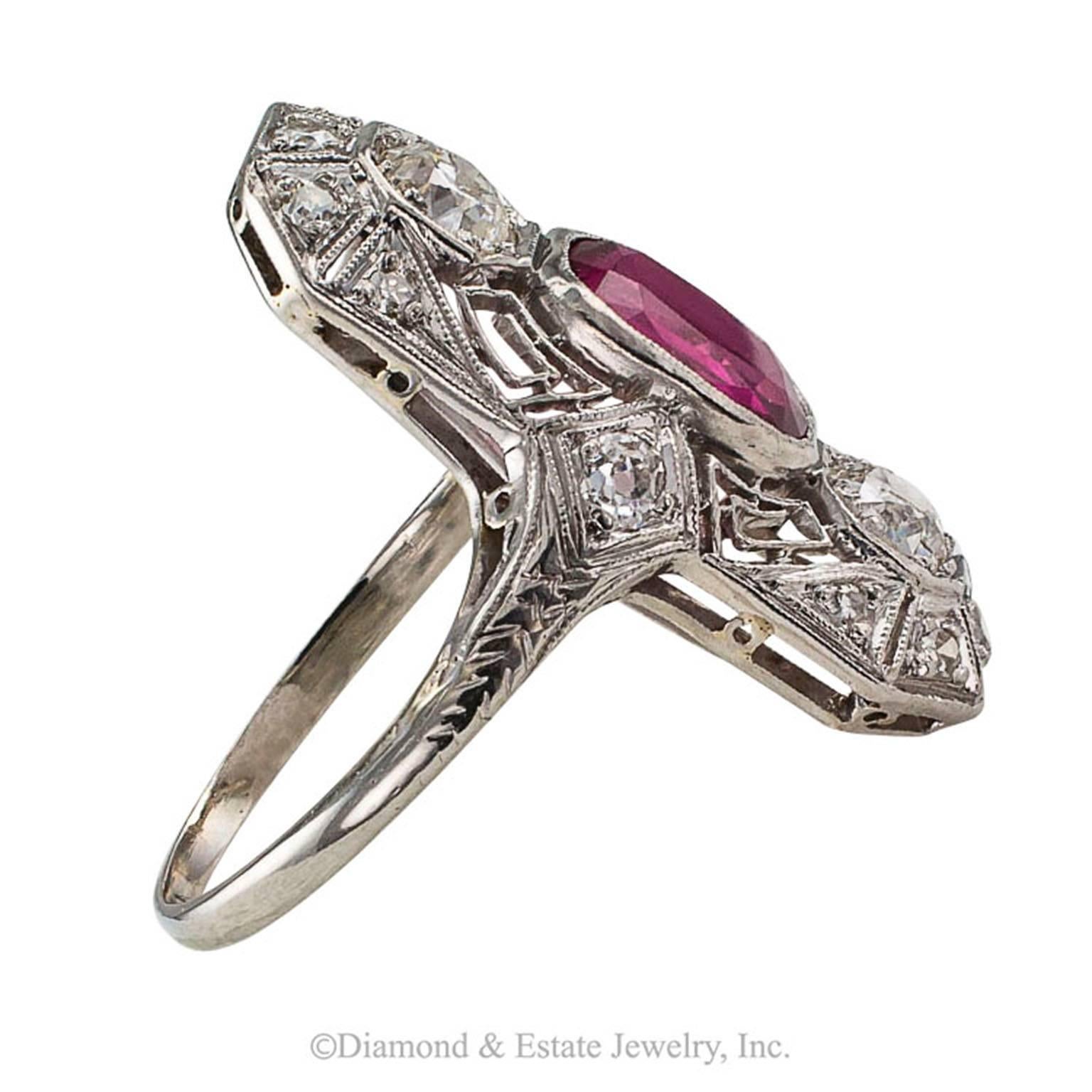 Art Deco Ruby Diamond Platinum Dinner Ring

Art Deco ruby and diamond platinum dinner ring circa 1925.  A single red cushion-shaped ruby weighing 1.56 carats flanked to the north and south by a pair of larger old European-cut diamonds on a
