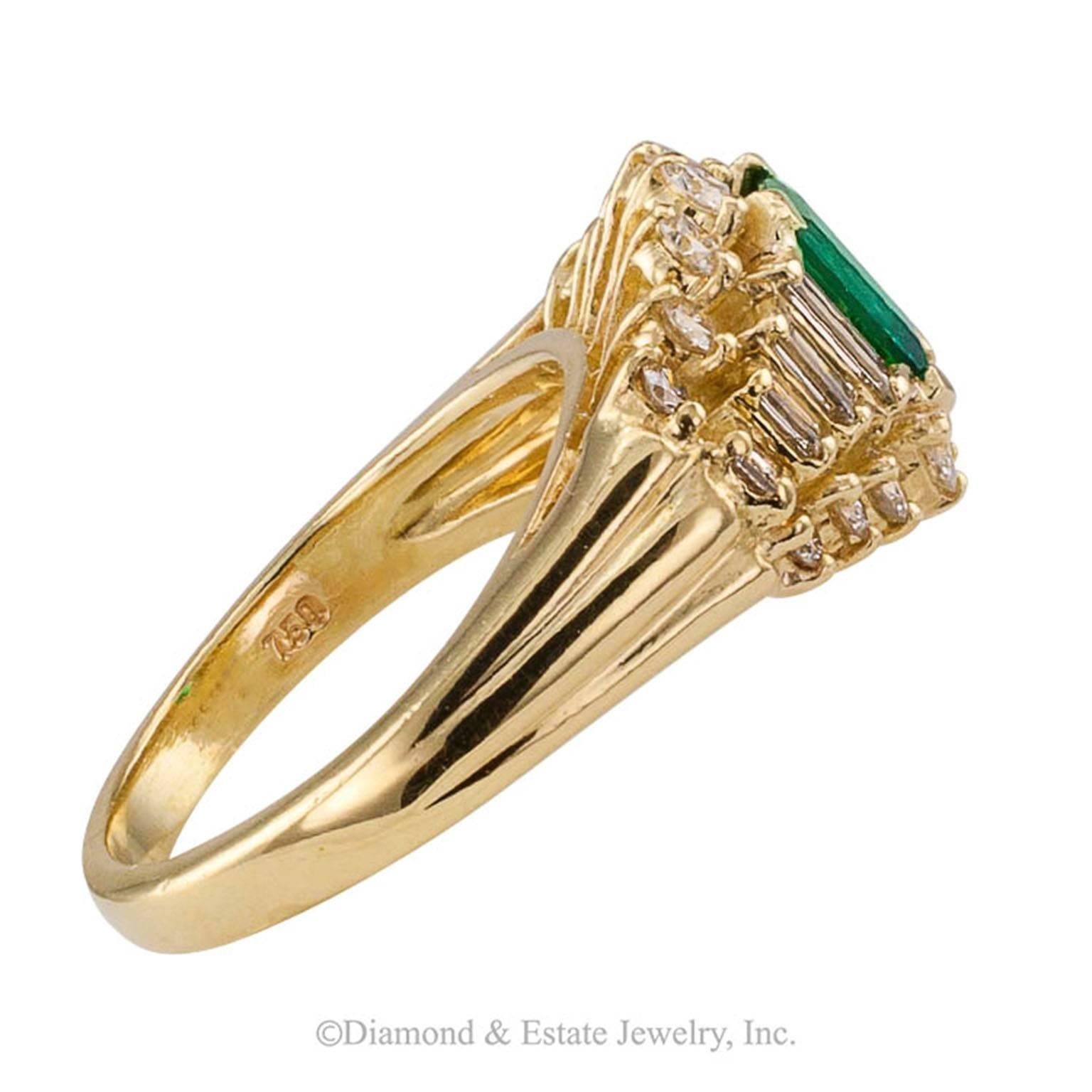 Emerald-cut Emerald Diamond Gold Ring

1980s fine emerald and diamond yellow gold ring.  The elegant 18-karat yellow gold design centers upon a very fine emerald-cut emerald weighing 0.61 carat, between stepped and tapering shoulders set with