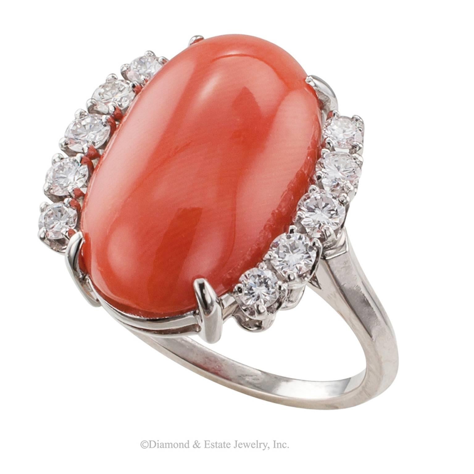 1970s Oval Coral Diamond Platinum Ring

1970s coral and diamond platinum ring.  Classic and fashionable design showcasing a moderate size, natural, oval coral displaying rich, beautiful deep orange-red color between shoulders set with round