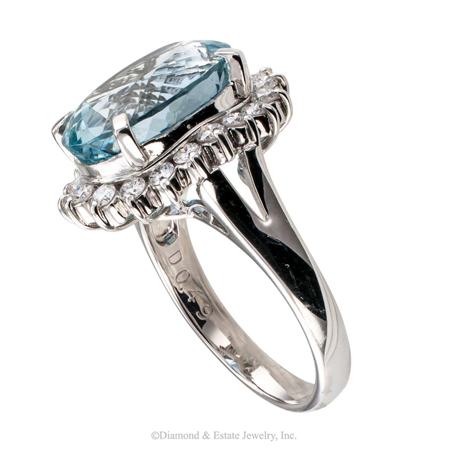 6.24 Carat Oval Aquamarine Diamond Platinum Ring

6.24 carats oval aquamarine and diamond platinum ring circa 1990.  A different twist on the classic halo ring design showcasing a moderate size oval aquamarine weighing 6.24 carats, displaying very