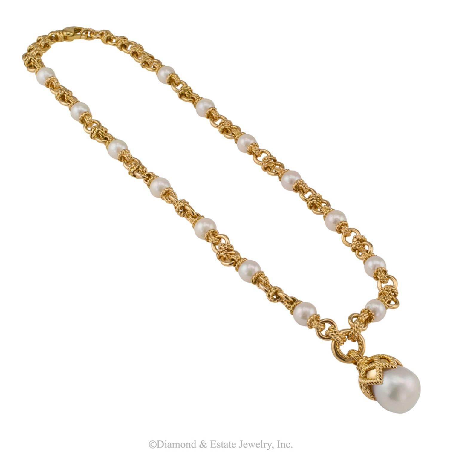Cultured Pearl South Sea Pearl Gold Necklace

Cultured pearl and cultured south sea pearl pendant 18-karat gold necklace circa 1990.  Fourteen cultured pearls measuring approximately 8 mm, spaced at equal intervals, between richly textured corded