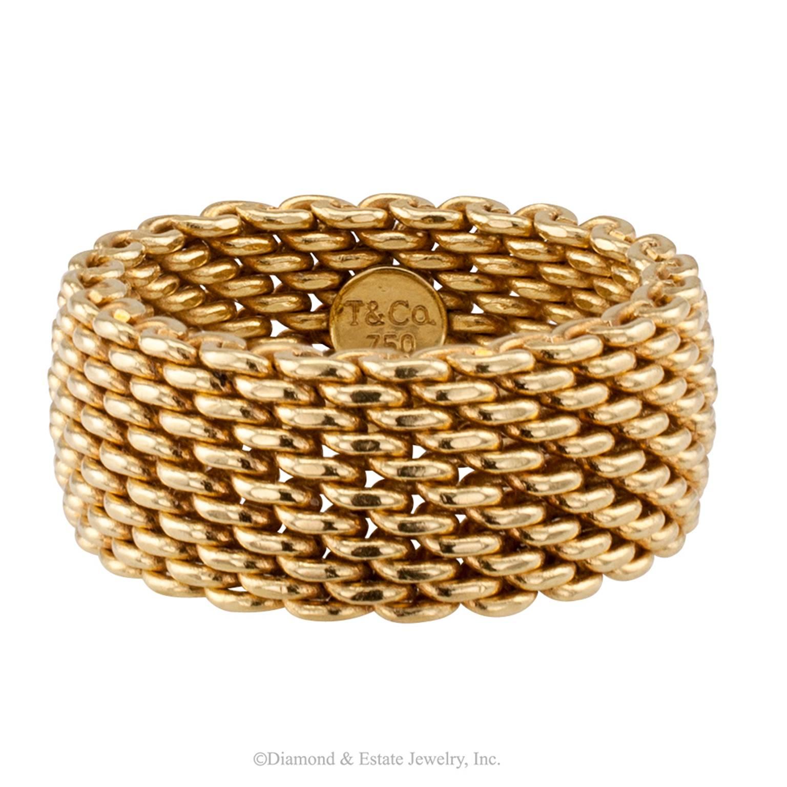 Tiffany Woven Gold Ring Band

Tiffany woven mesh ring band.  Solid 18-karat yellow gold links interwoven to form a wide ring band characterized by a pliable and silky texture, signed T & Co. for Tiffany and Company.  A unisex ring band.
 
RING SIZE: