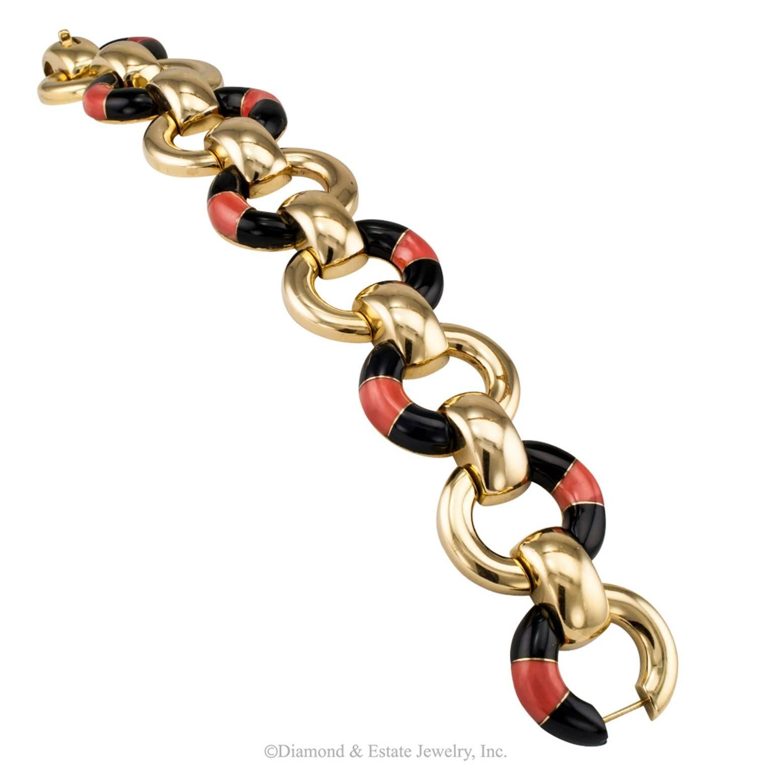 Coral Onyx Gold Link Bracelet

1970s Onyx and Coral link bracelet.  Seven oblong, open links, alternating a coral between black onyx motif that shapes into a visually striking pattern highlighted by brightly polished 18-karat gold.  The play of