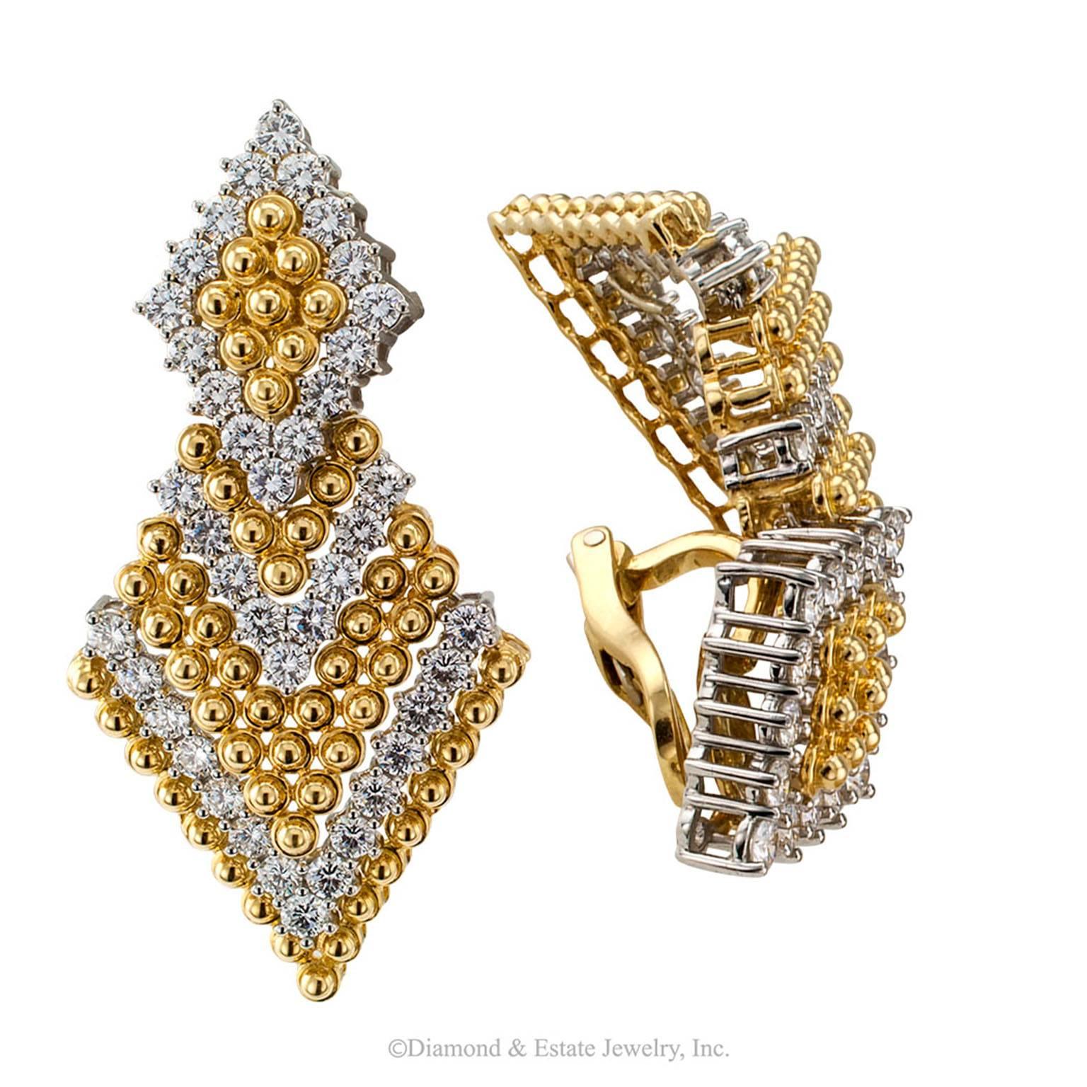 Triangular Door Knocker Diamond Yellow Gold Platinum Earrings

7.00 carats diamond gold and platinum pendent earrings circa 1990.  The articulated bottoms on these divine earrings help set those diamonds literally on fire with the slightest